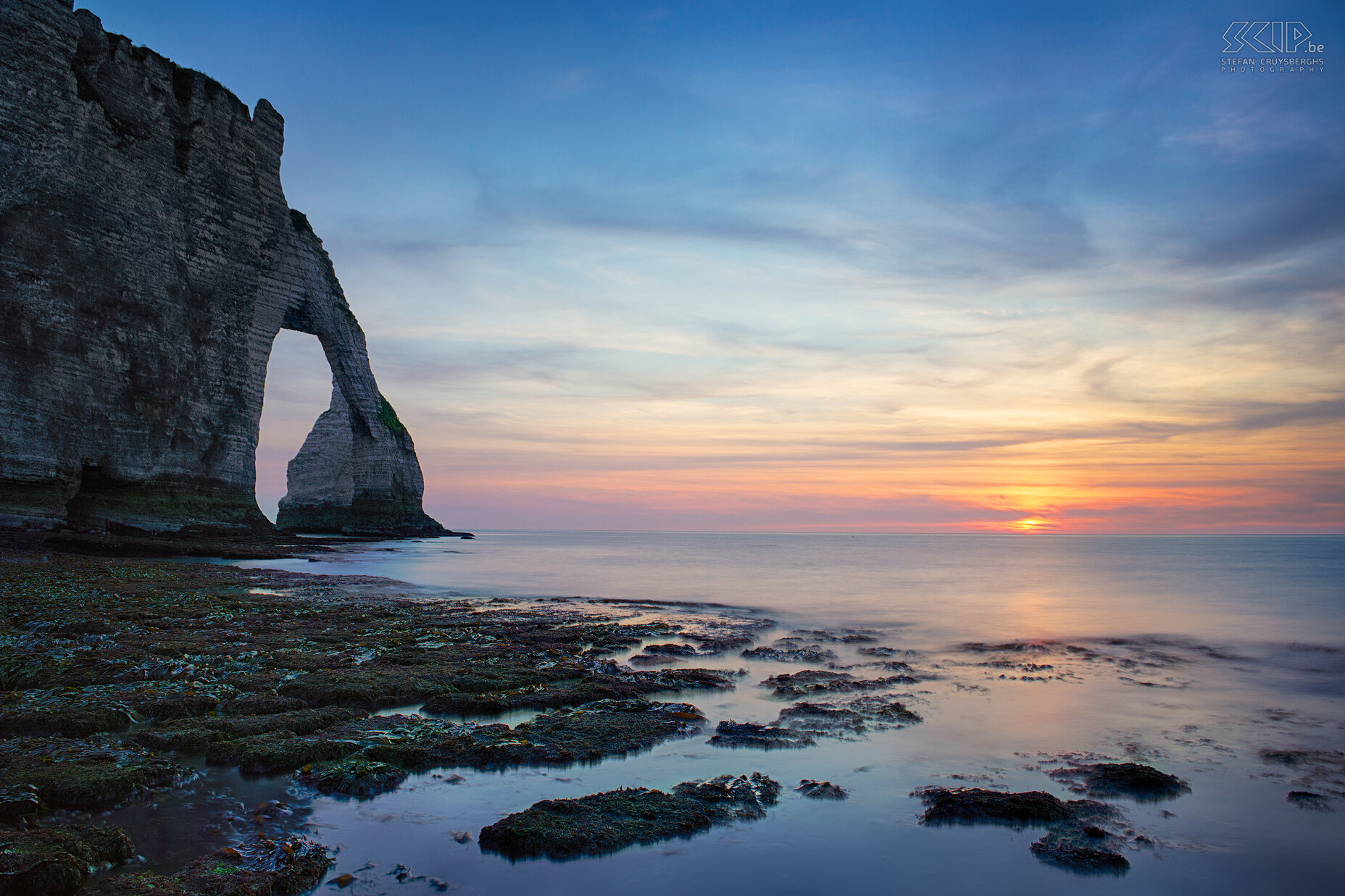 Normandy - Sunset Étretat We ended our trip at Étretat, a commune in the Seine-Maritime department in the Haute-Normandie region in France. There are wonderful white cliffs and three arches. It was low tide so I could make some sunset shots near the arch which is called 'Porte d'Aval'. Stefan Cruysberghs